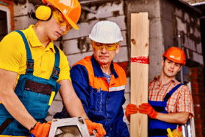Körperliche Belastung am Arbeitsplatz: Beispiele können die Arbeit auf einer Baustelle oder an einem unergonomischen Büroarbeitsplatz sein.
